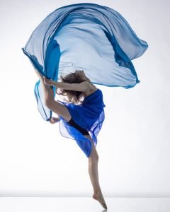 Dancer in dress with blue fabric on white background dancer in dress with blue fabric on white background